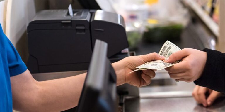 A photo of two people passing cash between themselves.